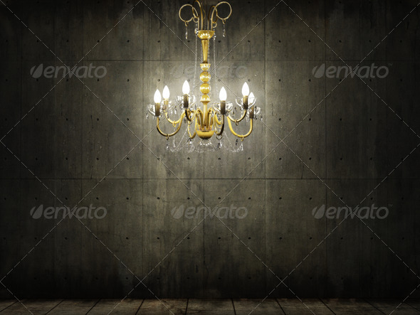 interior scene of golden chandelier in a grungy and dark concrete room