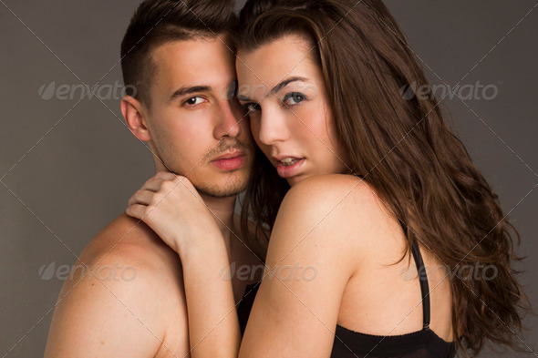 Young passion couple on gray isolated background