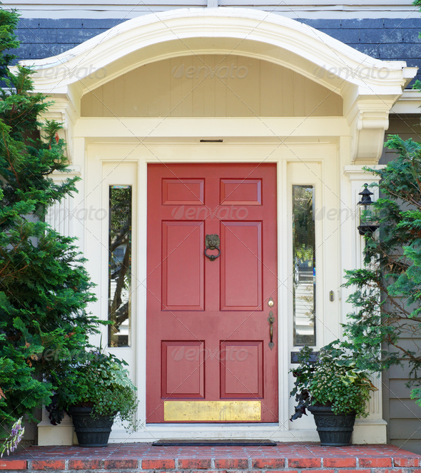 Magenta home door with arched top with two windows