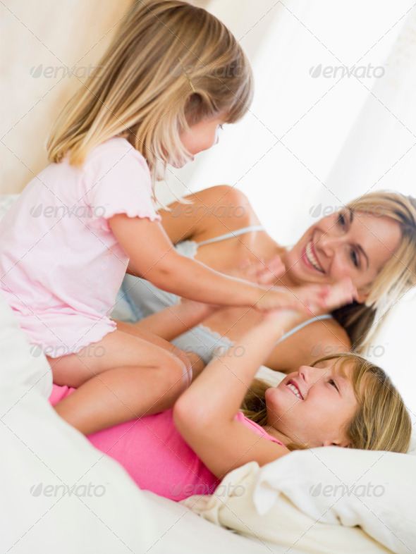 banana boobs Woman and two young girls in bed playing and smiling PhotoDune