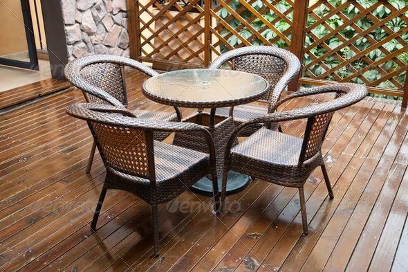 wicker chairs and table on hardwood front deck