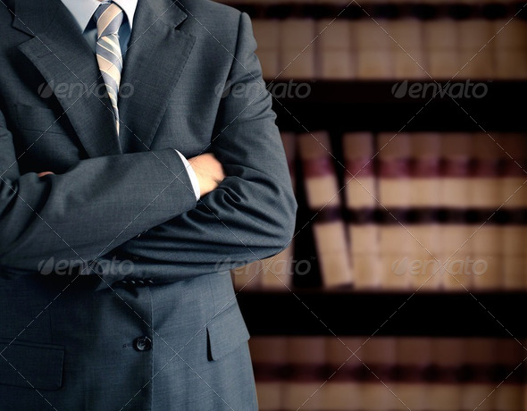 Businessman wearing a suit in front of a bookcase