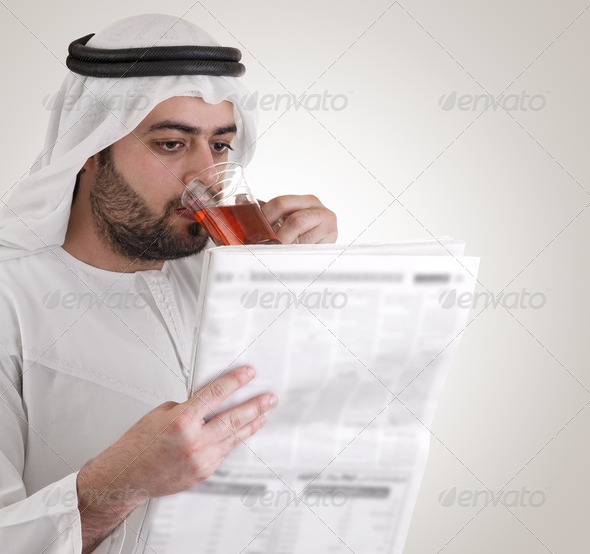 arabian business man drinking tea & reading news