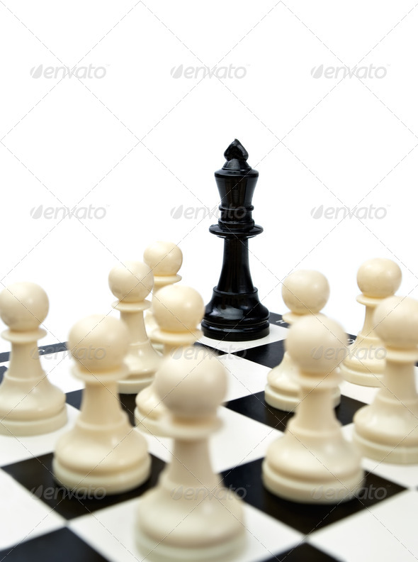 black king in the corner surrounded with the white pawns which can suggest victory of ordinary people over the bad leader, rebellion,revolution or riot.., focus on the king