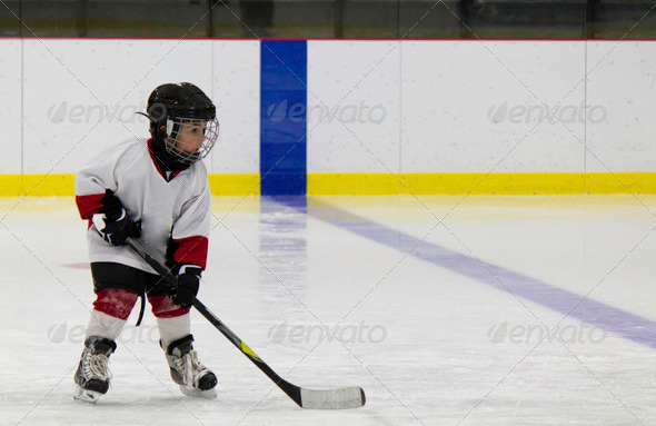 Little boy playing ice hockey
