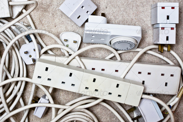 Electric plugs, adaptors and extension leads as a background