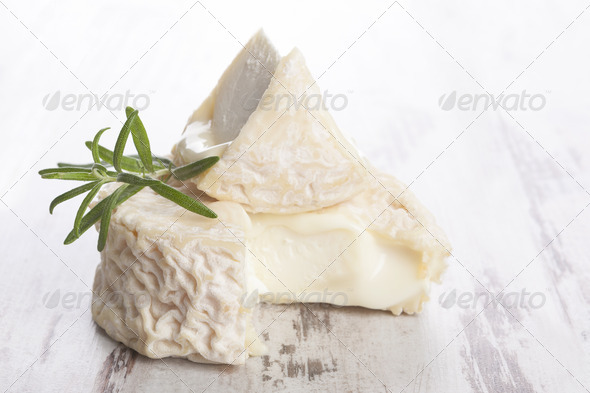 Luxurious goat cheese white wooden background. Luxurious culinary cheese still life.