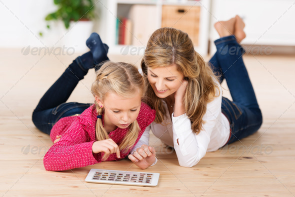 Mother and daughter playing with a tablet