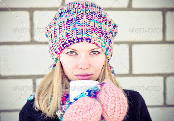 Young beautiful Woman drinking hot coffee winter time