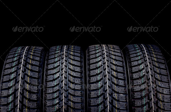 Winter car tires isolated on black background
