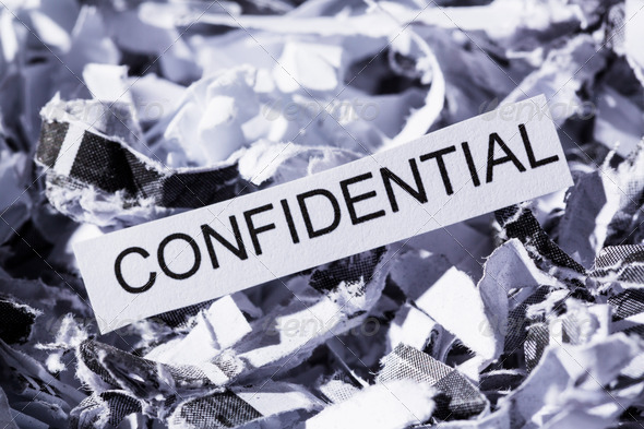 shredded paper tagged confidential, symbol photo for data destruction, banking secrecy and confidentiality