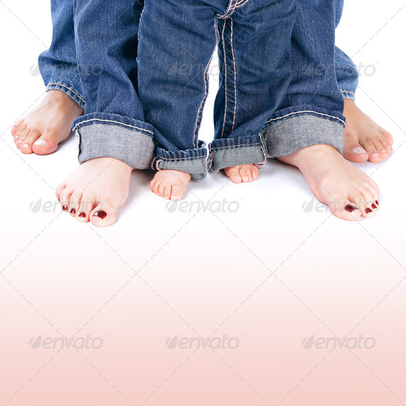 Mother, father and little child wearing blue jeans, barefoot people legs isolated on white background, body part, family togetherness concept