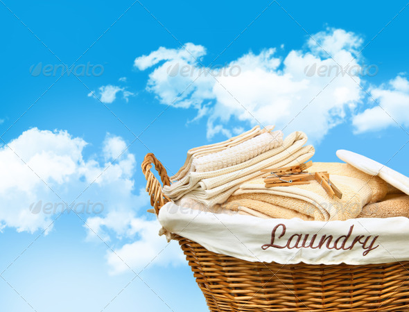 Laundry basket with towels against a blue sky