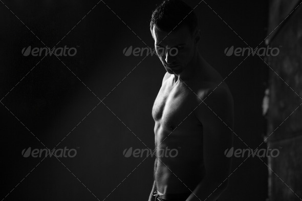 Black and white photo of a muscular man