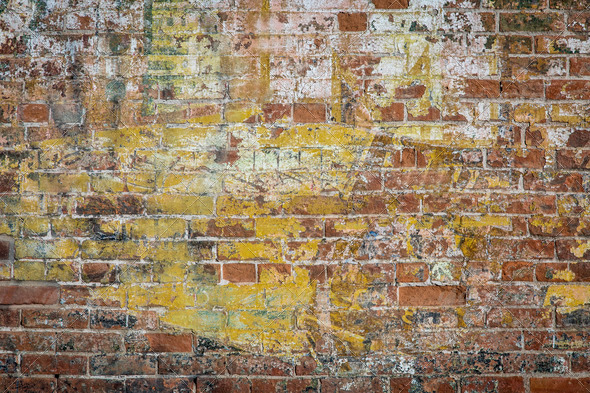 background texture of a grunge brick wall with graffiti remains