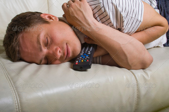 Man falling asleep with TV remote control