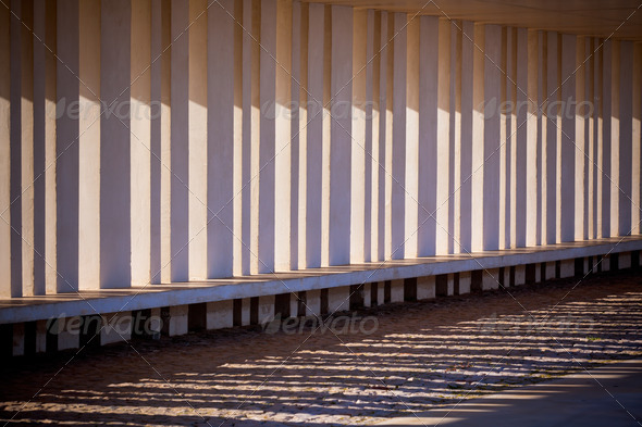 Sunlight and Shadows Through Columns of Building