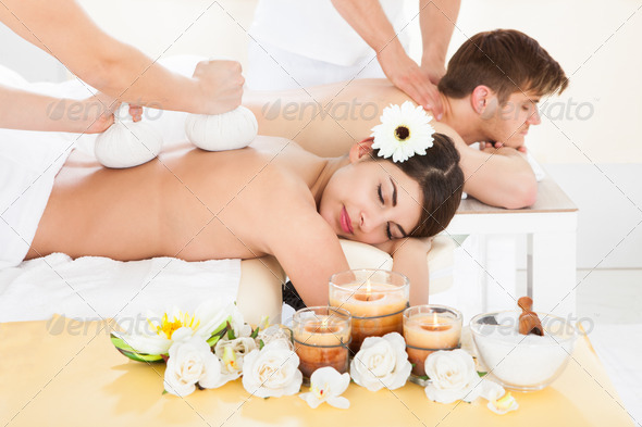 Couple Receiving Back Massage In Spa